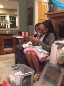 Jasmine opens a gift for her baby girl